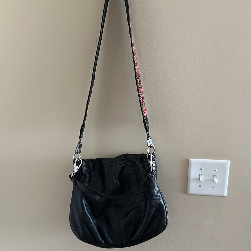 Black leather Margot crossbody bag with guitar strap